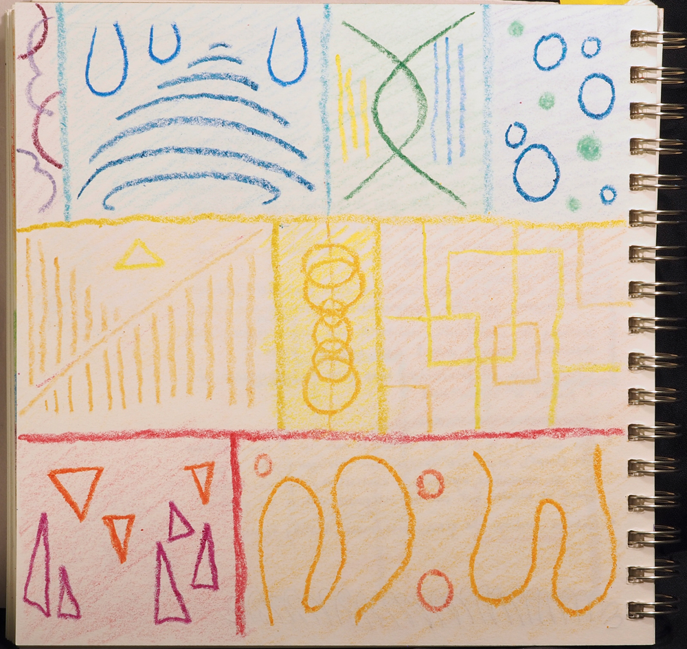 A notebook page with colorful abstract boxes and shapes, all drawn in crayon.